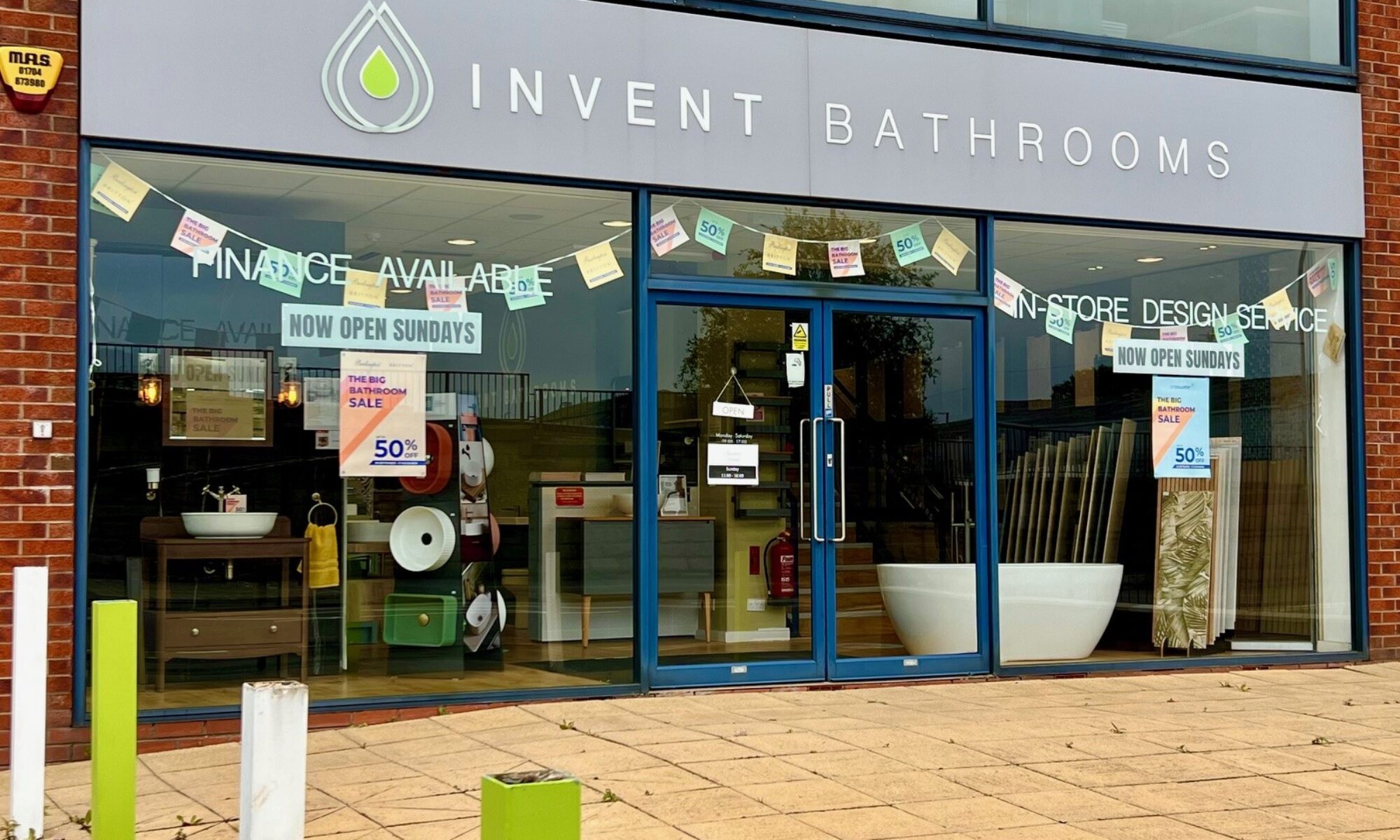 Invent Bathrooms Shopfront with Now Open Sundays banners